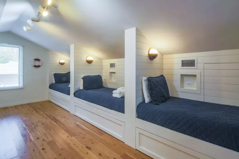 The kids' bunk room features 3 built-in twin beds on one wall of the room.