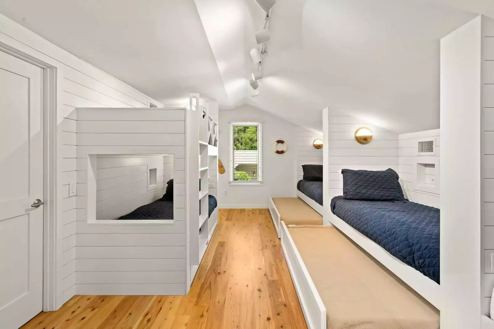 There are three twin trundle beds under three of the twin beds.