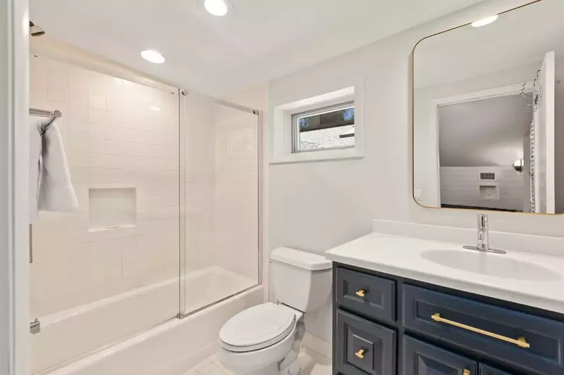 The en suite bathroom for the bunk bedroom features a shower/tub combo.