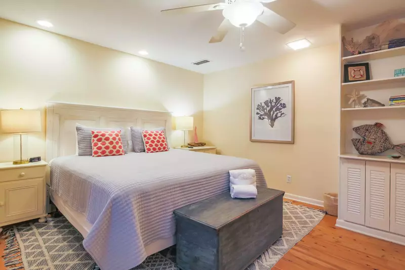 The king suite features a king bed, night stands with reading lamps and a built-in bookcase.