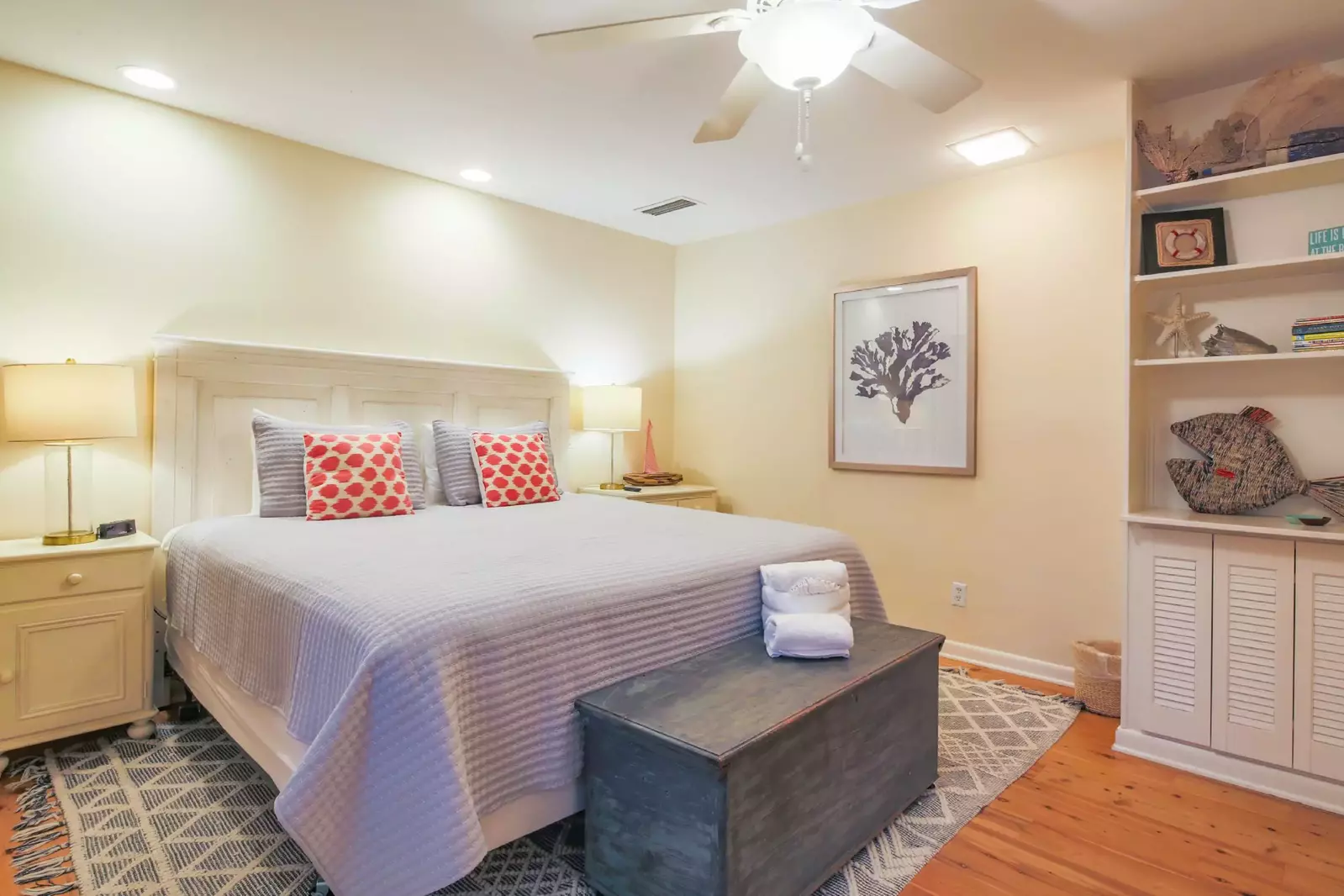 The king suite features a king bed, night stands with reading lamps and a built-in bookcase.