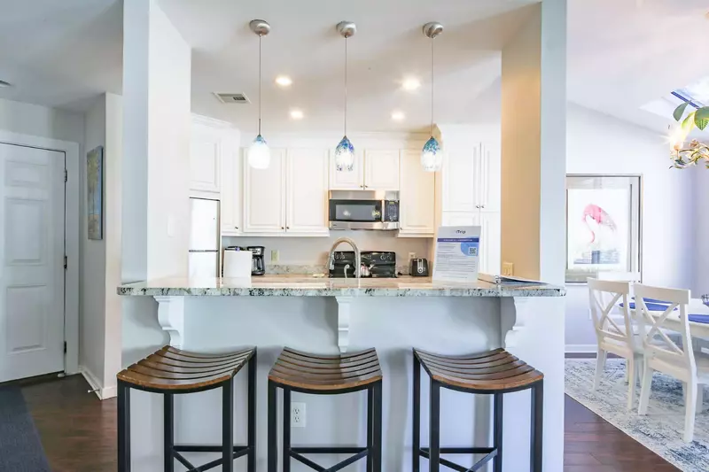 There are three stools at the kitchen counter.