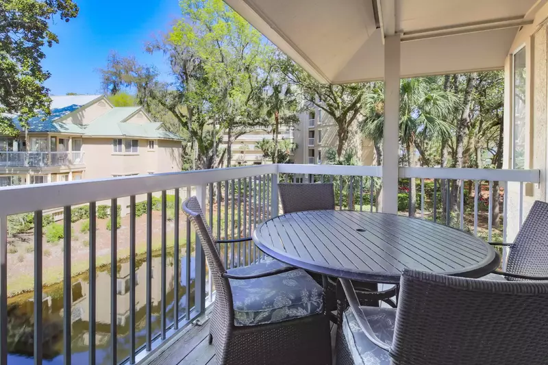 The covered balcony has a dining table that seats 4.