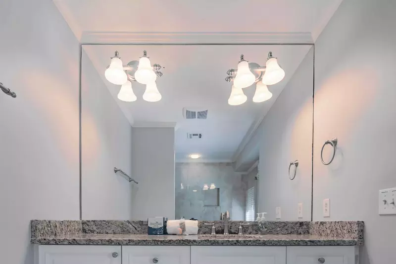 The en suite bathroom features a spacious vanity with lots of storage area.