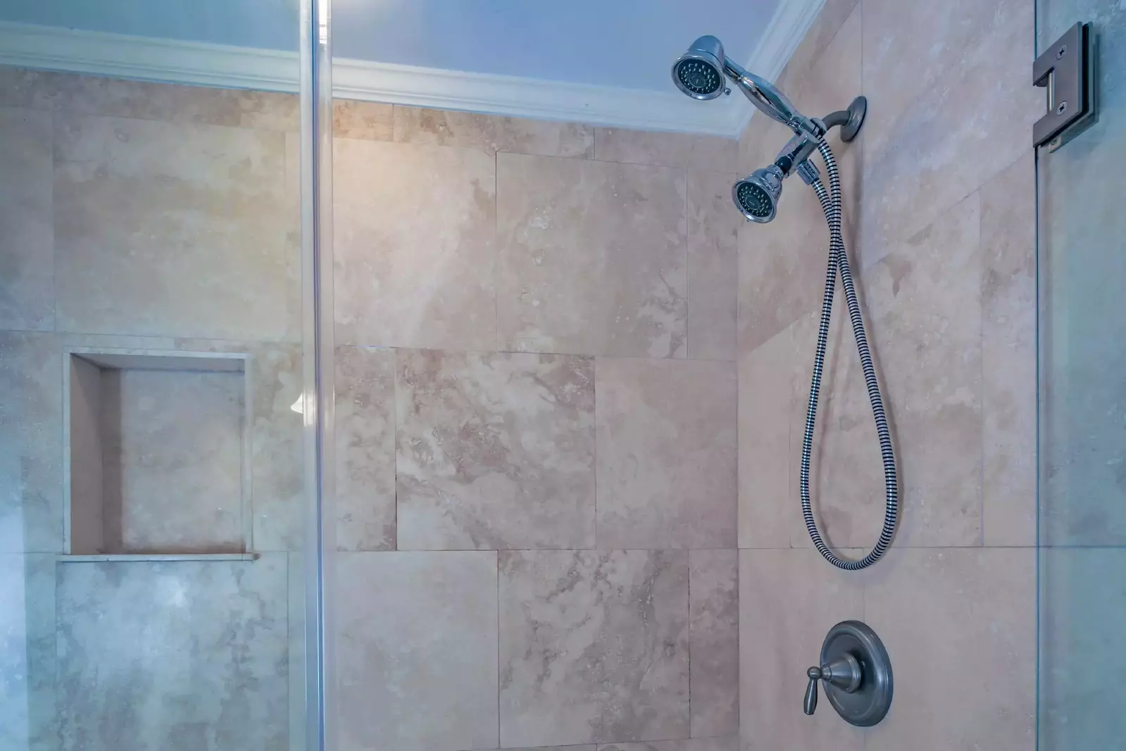 The tiled, walk-in shower has two shower heads.