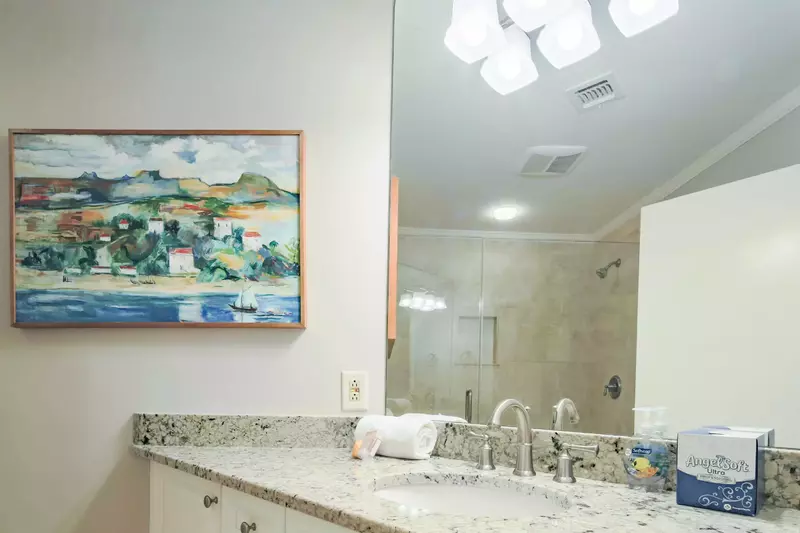 This hallway bathroom features a spacious vanity.