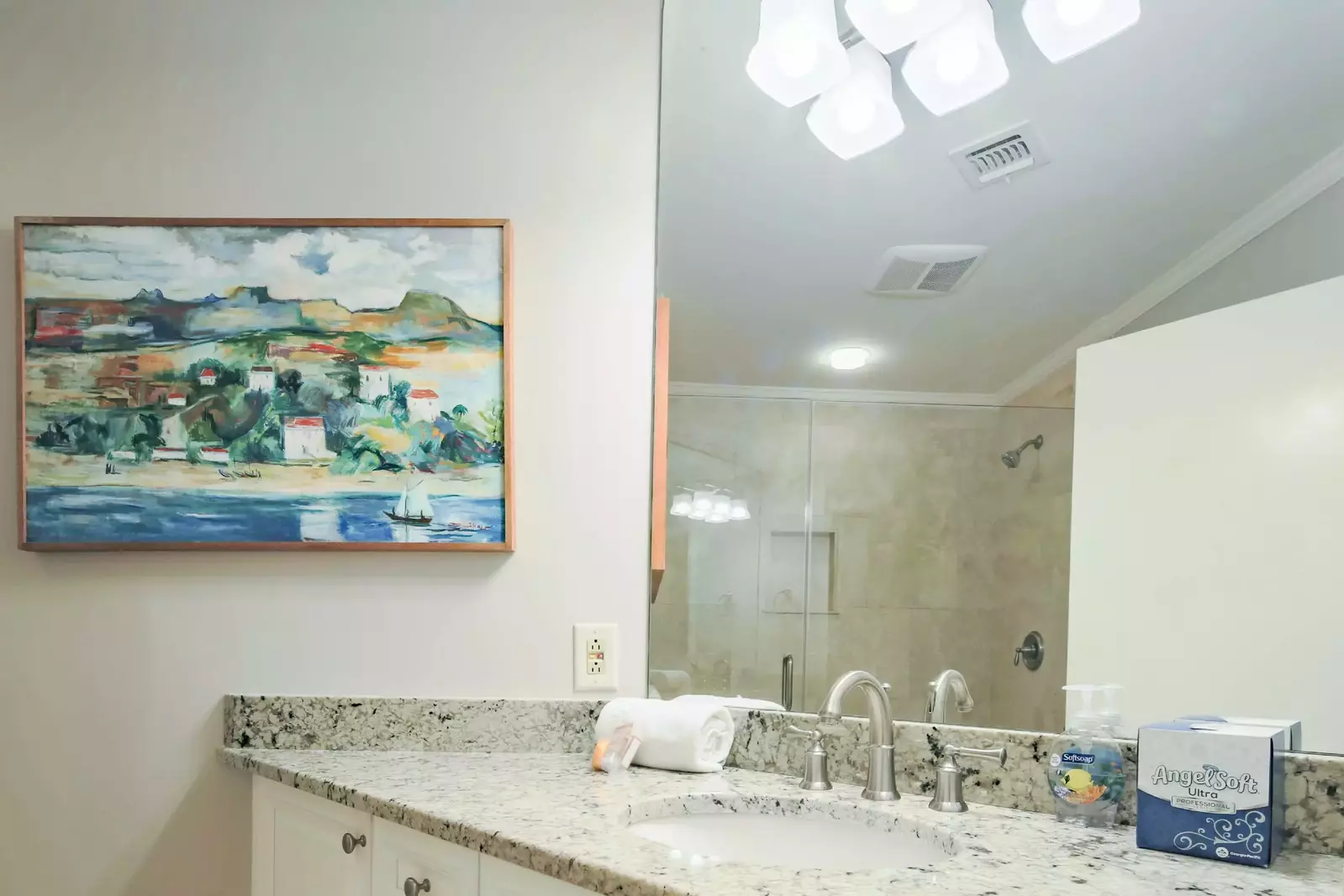 This hallway bathroom features a spacious vanity.