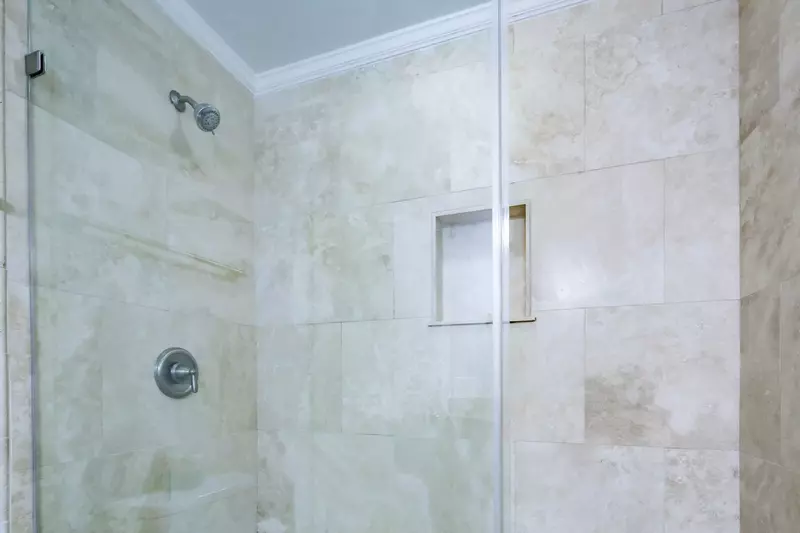 The hallway bathroom also has a tiled, walk-in shower.