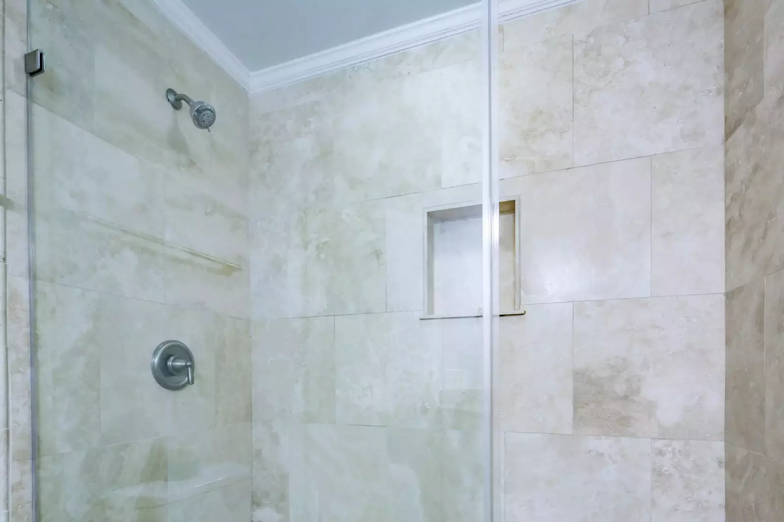 The hallway bathroom also has a tiled, walk-in shower.