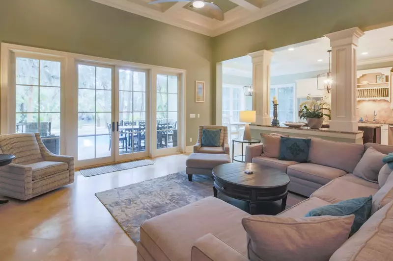 The open layout between the living room, kitchen and dining room creates stunning views of the pool & patio area.