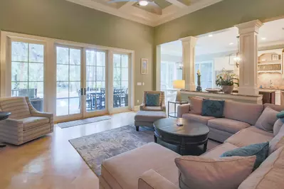 The open layout between the living room, kitchen and dining room creates stunning views of the pool & patio area.
