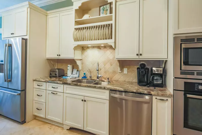 There is also a refrigerator, dishwasher, oven, microwave, coffee maker and toaster.