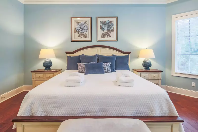 The master suite has a night stand with reading lamp on both sides of the king bed.