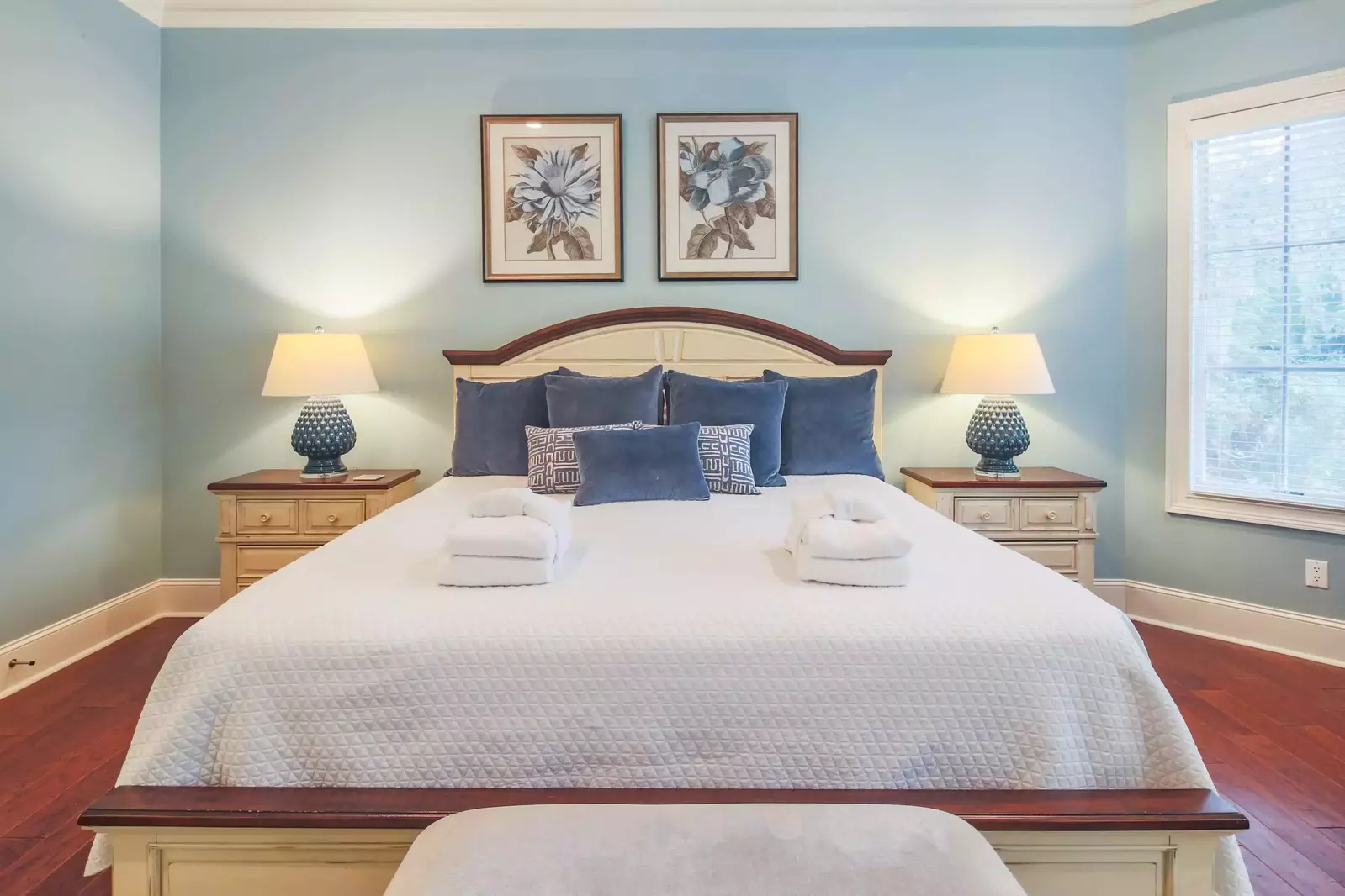 The master suite has a night stand with reading lamp on both sides of the king bed.