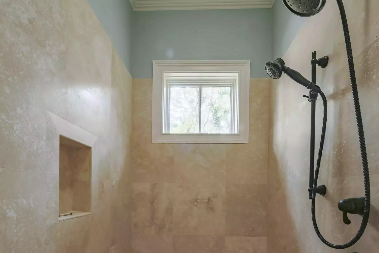 The en suite bathroom also has a tiled, walk-in shower.