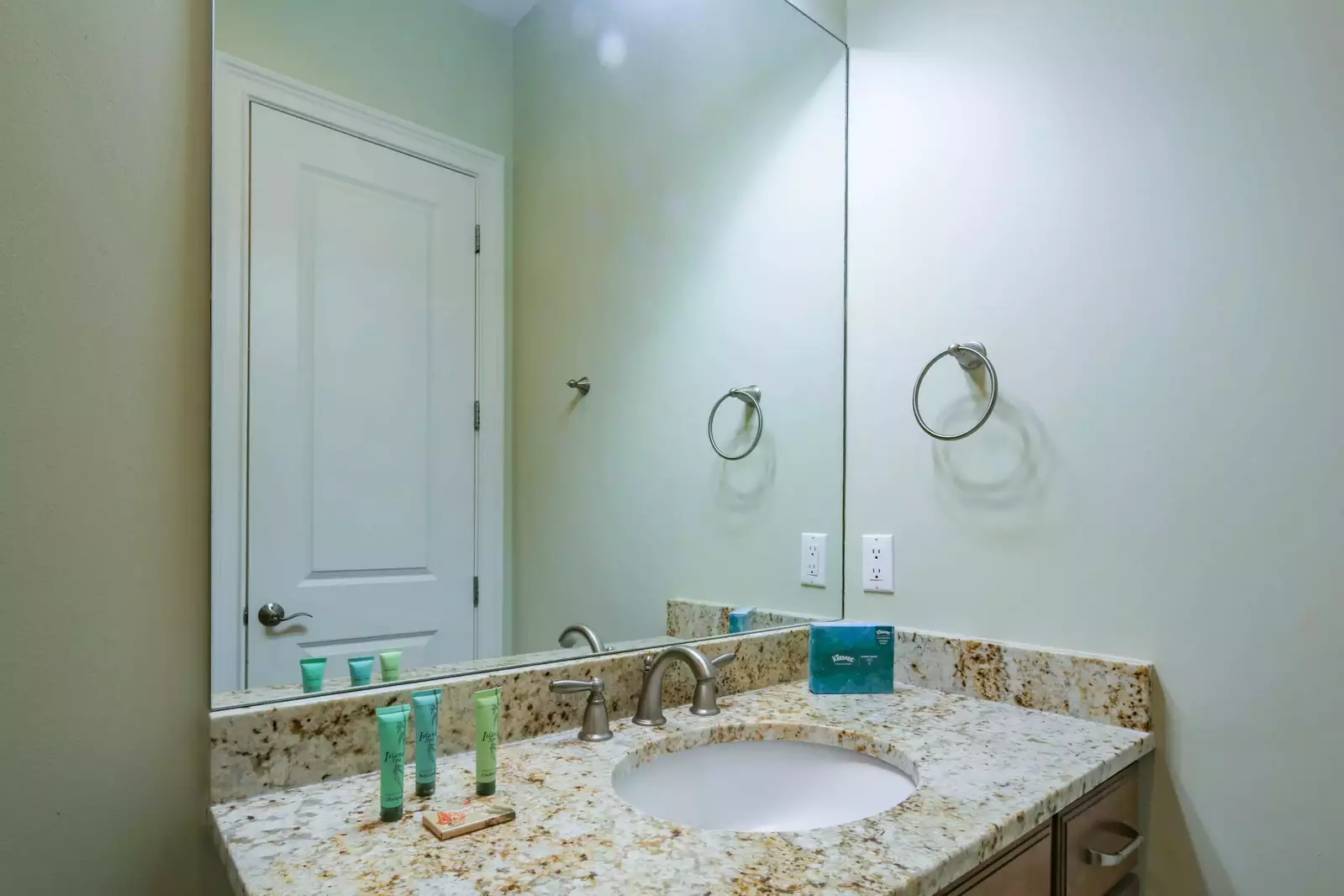 The en suite bathroom features a spacious vanity.