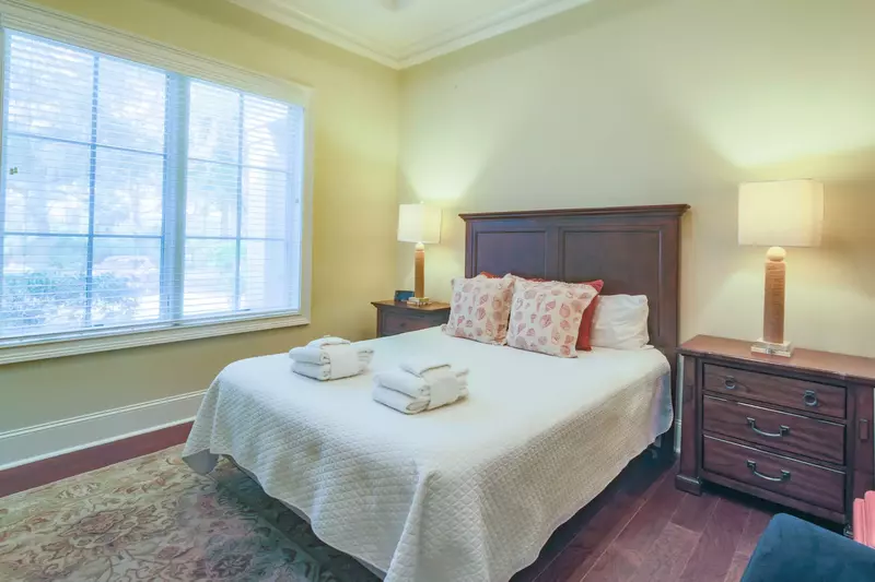 The queen suite features a queen bed and views of the front side of the home.