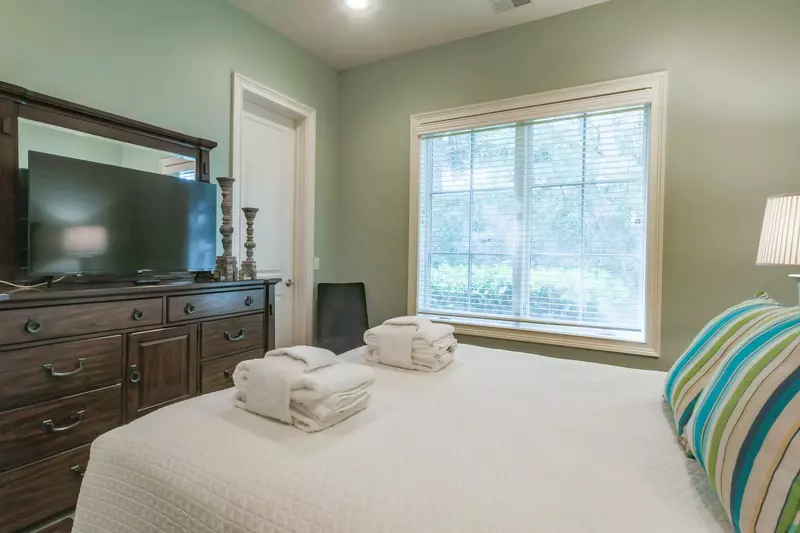 This guest bedroom also features a dresser and TV.