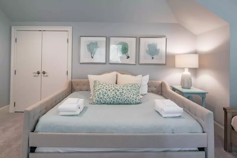 This suite features a full bed with a twin trundle bed tucked away below.