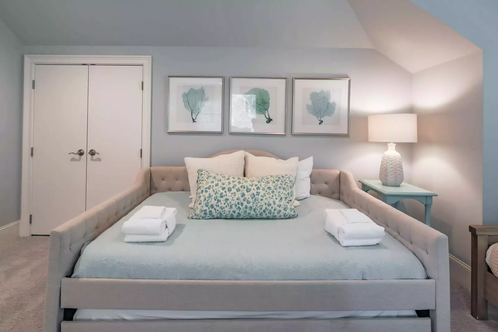 This suite features a full bed with a twin trundle bed tucked away below.