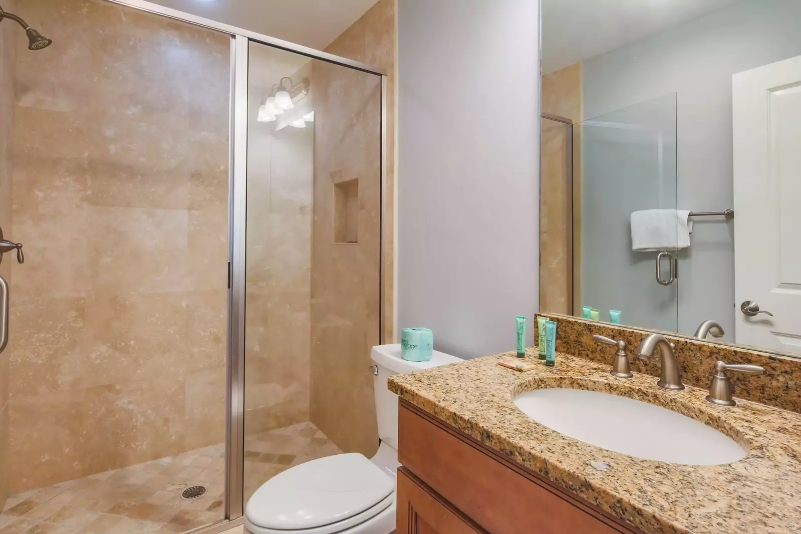 The en suite bathroom features a spacious vanity and a walk-in shower.