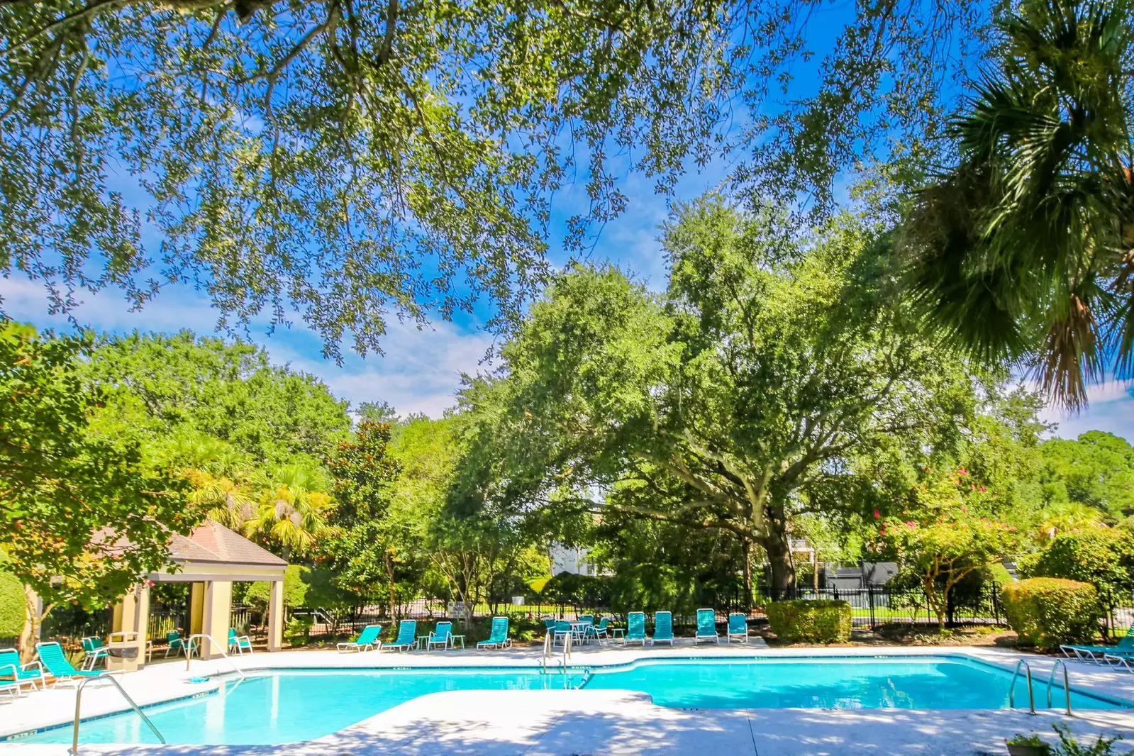The community pool area features sun loungers, a spacious pool and a covered gazebo.