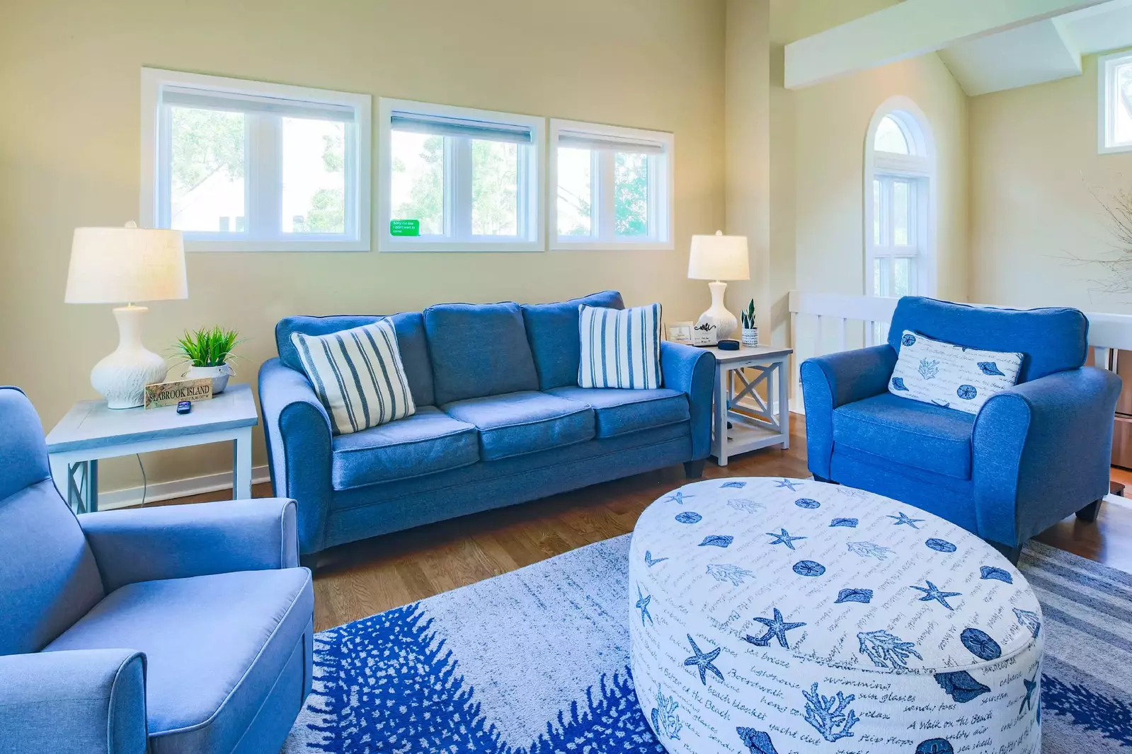 The living room features a spacious seating area (including a queen sleeper sofa).