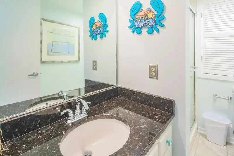 The upper level bathroom features a spacious vanity.