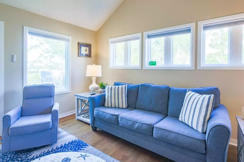 The living room looks out onto the screened porch and deck (which are accessible through the living room).