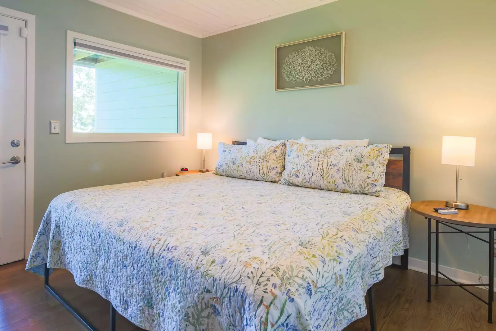 On the lowest level of the home, you will find the bedroom with king bed, night stands & reading lamps.