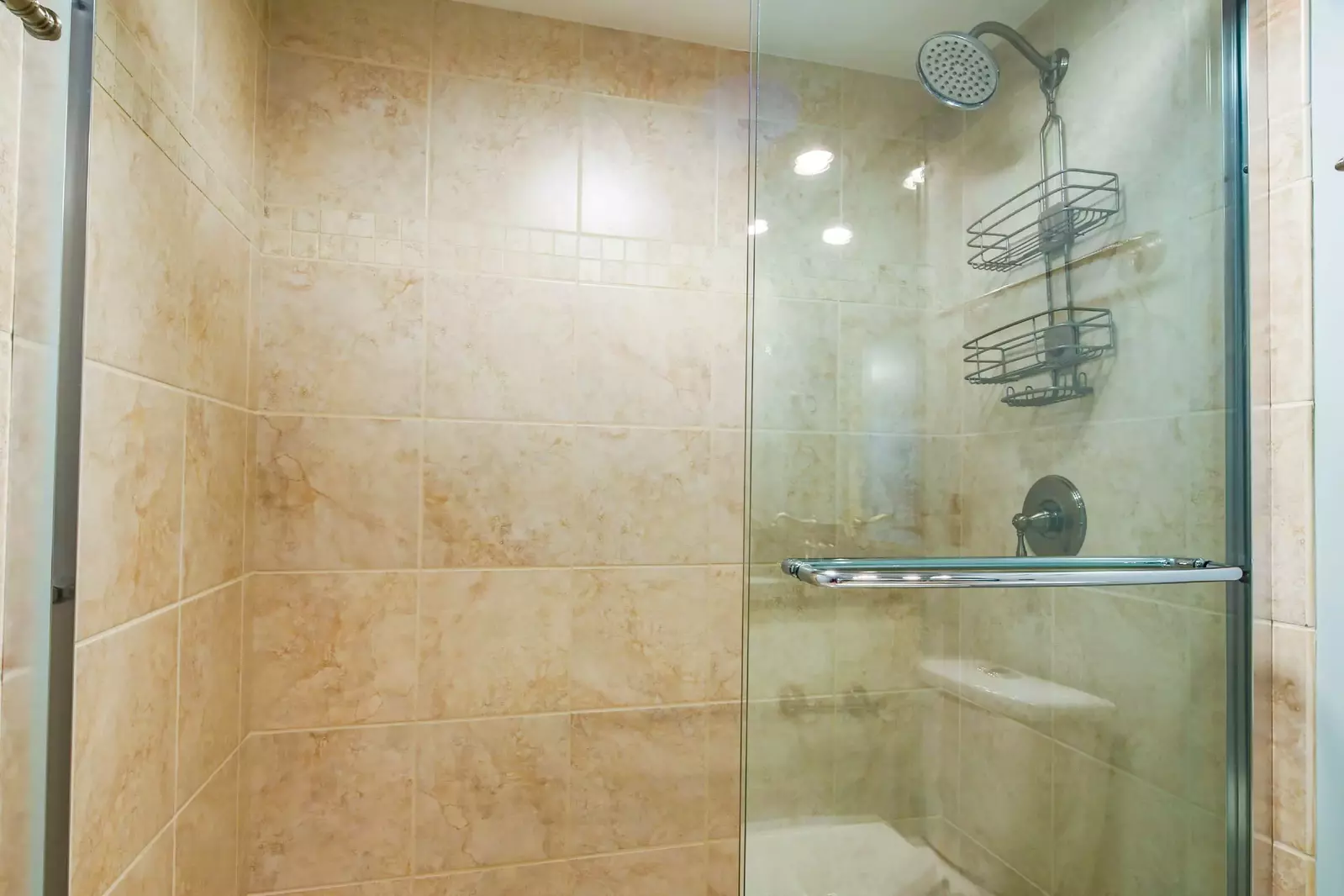 The en suite bathroom also has a tiled, walk-in shower.