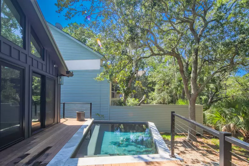 Step out onto the back deck to find the home's private pool with in-pool bench seating.