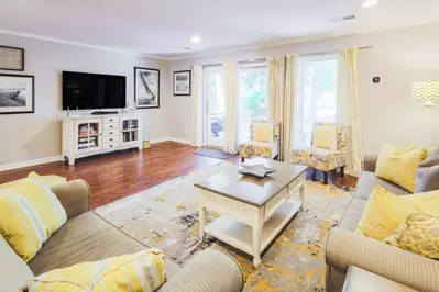 The living room receives lovely natural light through the door & windows that look out onto the back deck.