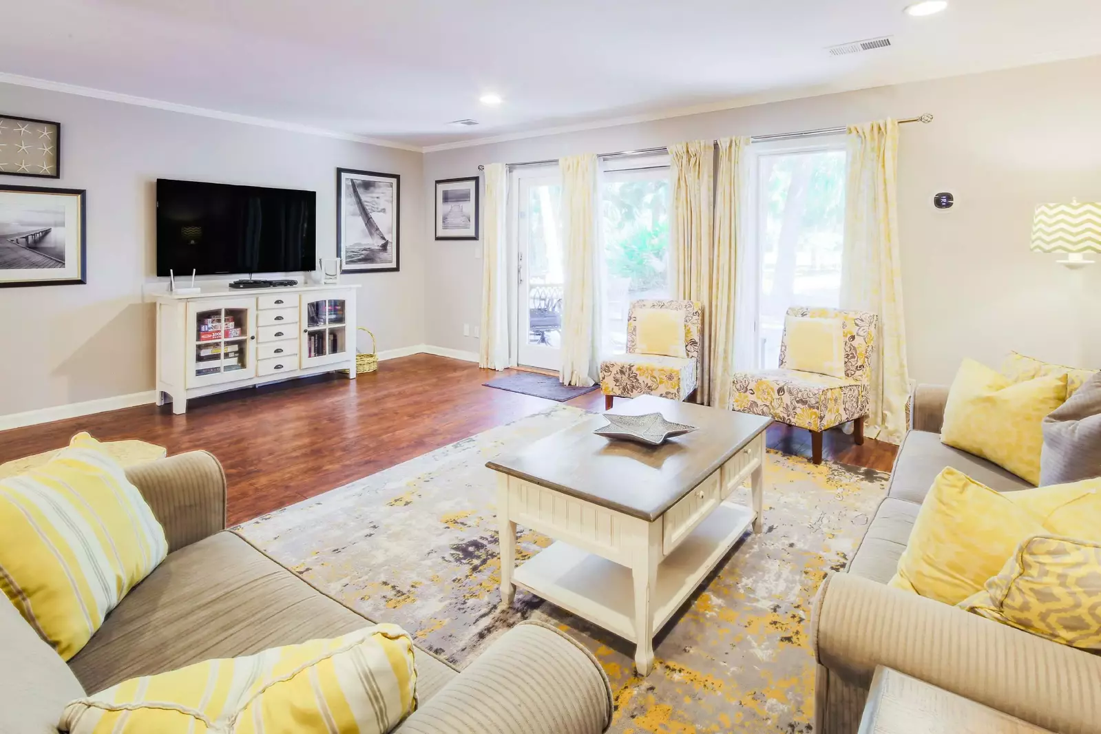 The living room receives lovely natural light through the door & windows that look out onto the back deck.