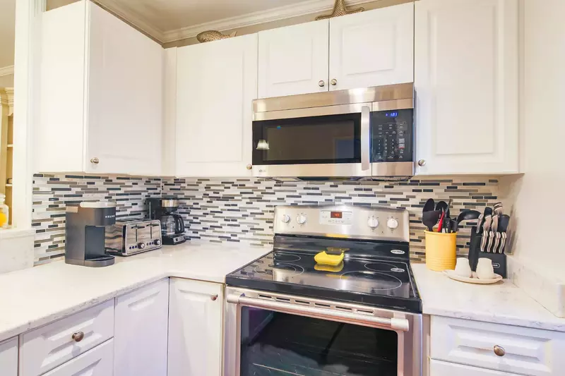 There is also a tiled backsplash, drip coffee maker and keurig in the kitchen.