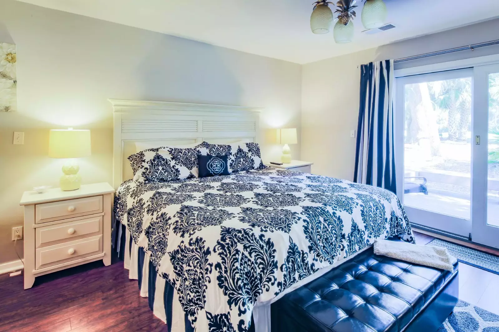 The primary suite features a king bed and night stands with reading lamps.