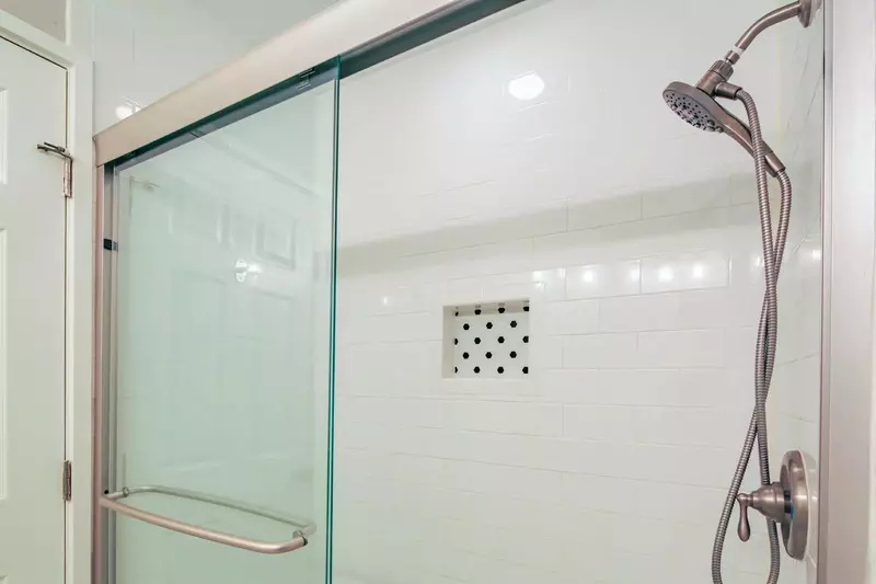 The en suite bathroom also features a tiled, walk-in shower.