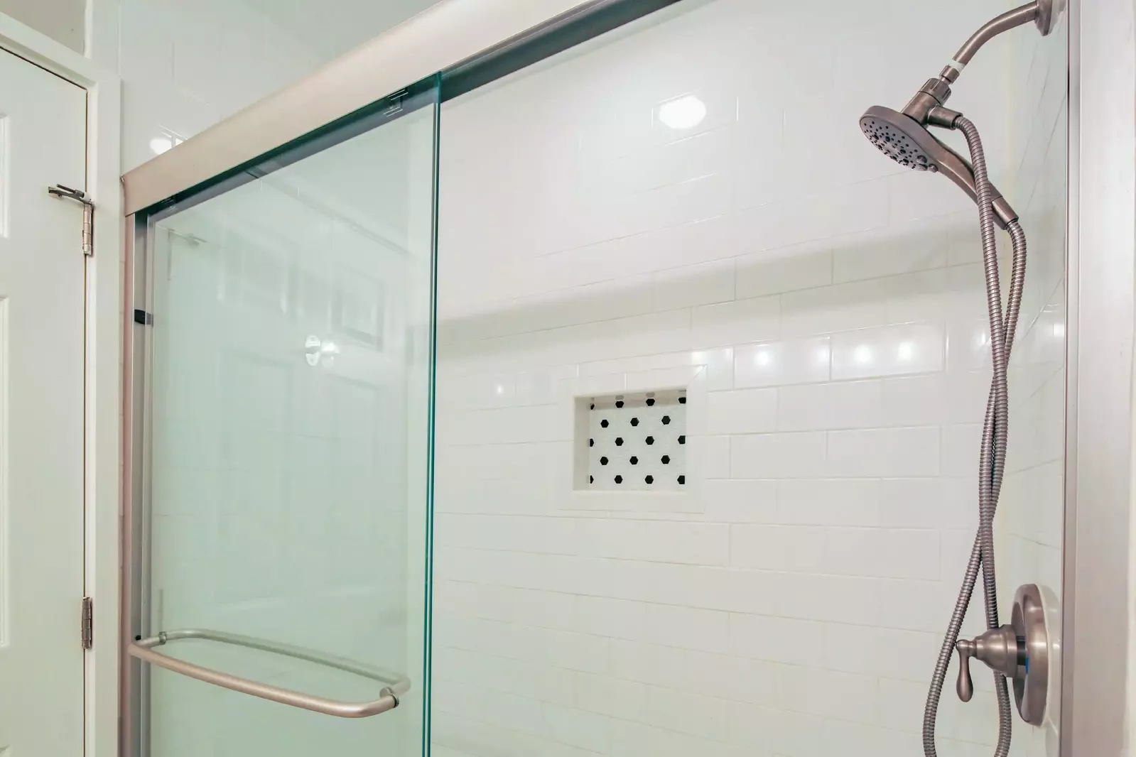 The en suite bathroom also features a tiled, walk-in shower.