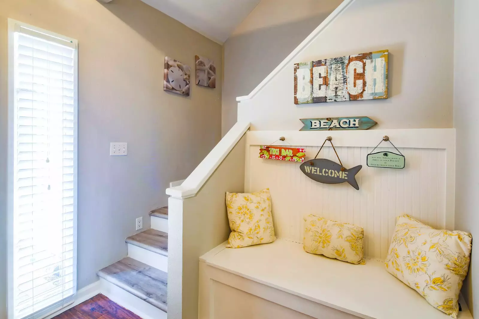 This stairwell near the front door leads to the two bedrooms and one bathroom on the second floor.