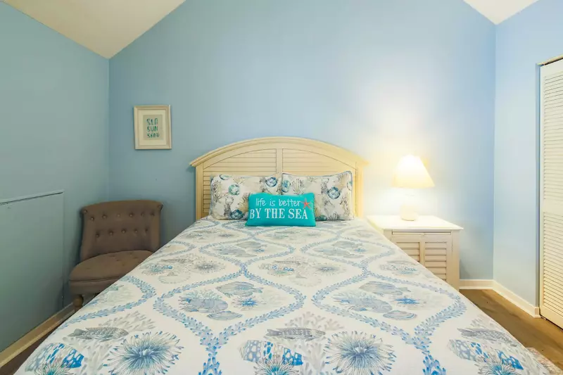 The queen bedroom also has a chair and closet.