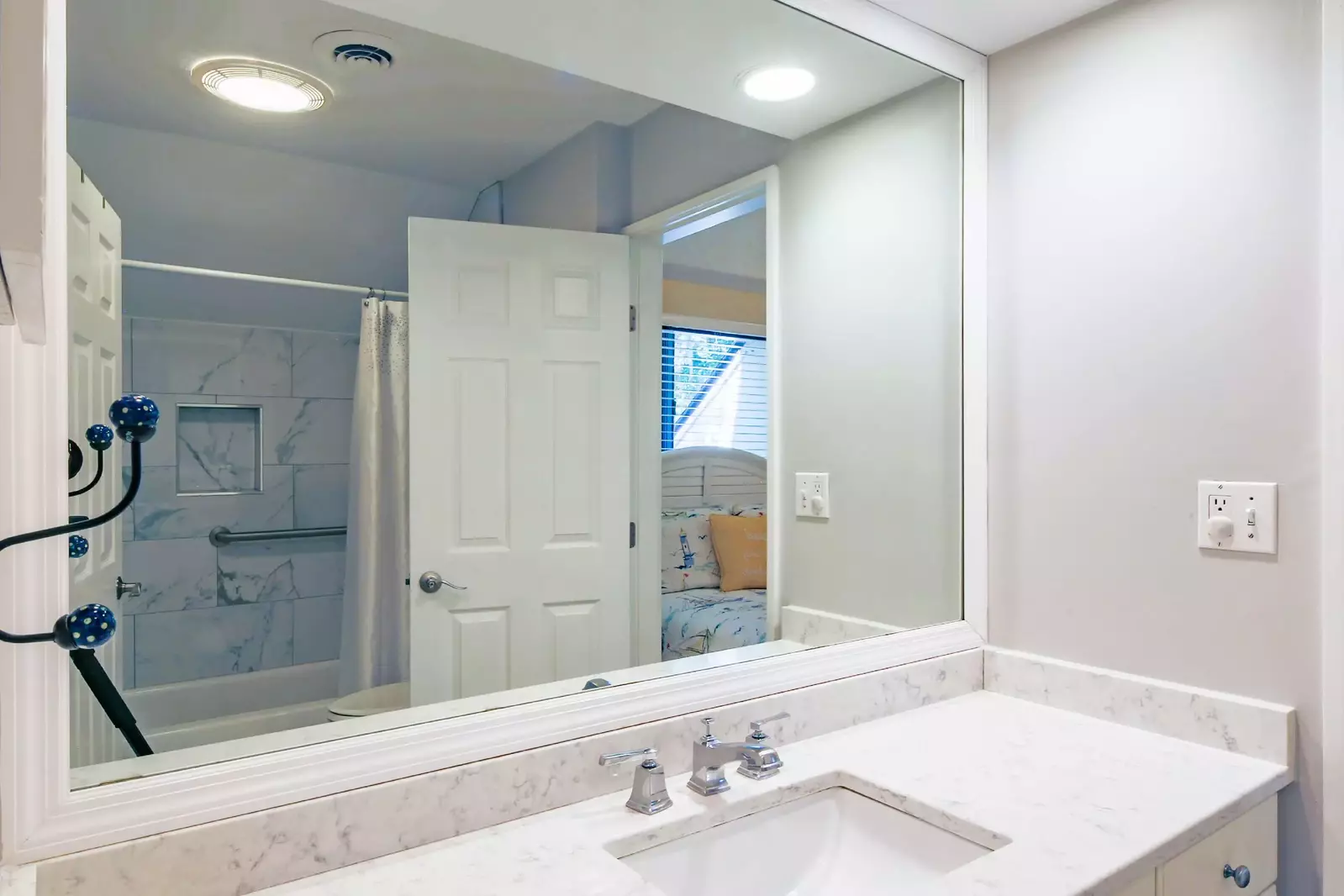The jack & jill bathroom features a spacious vanity and a shower/tub combo.