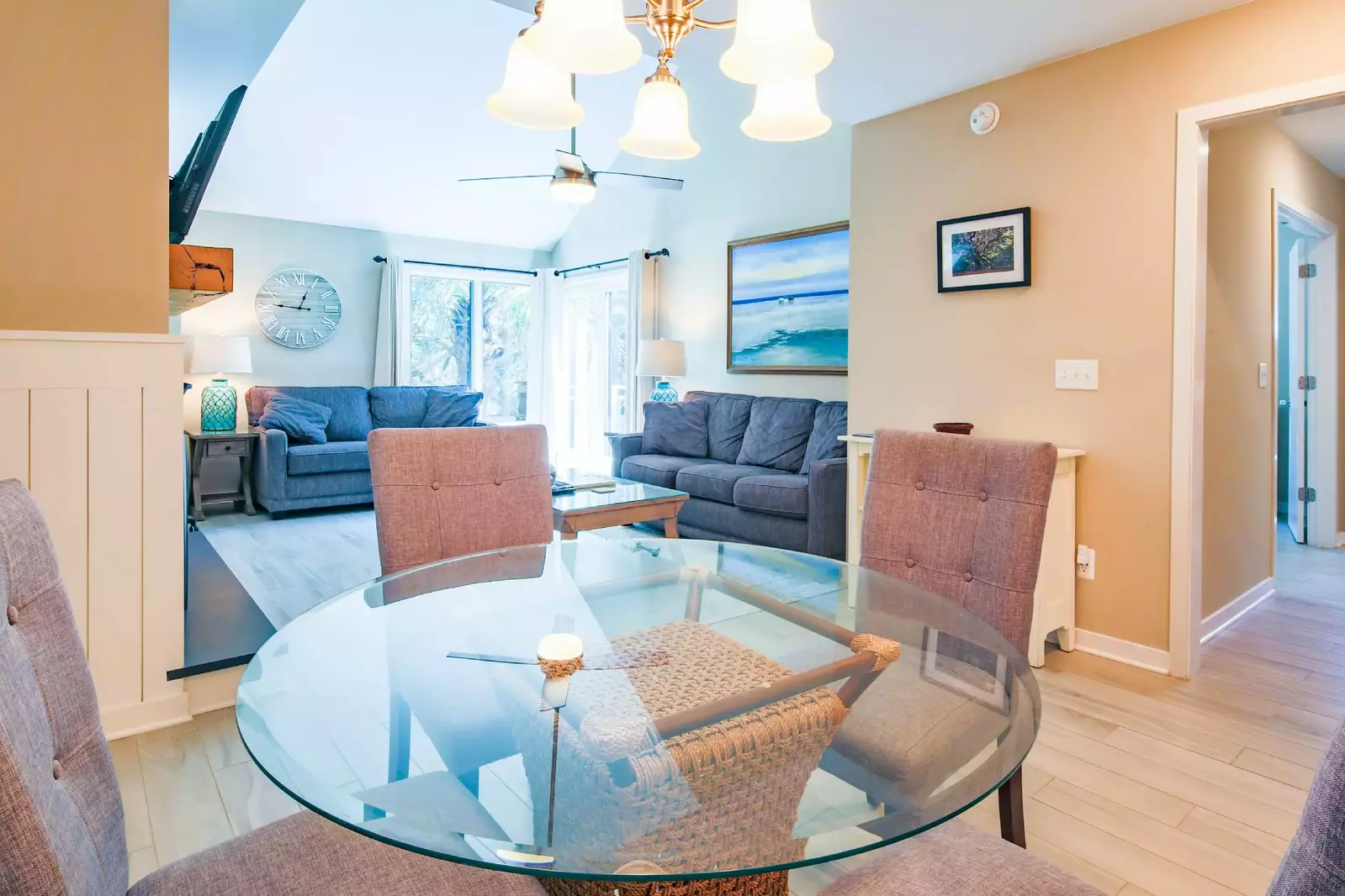 The dining table looks out into the living room and down the hallway to the bedroom & bathroom.