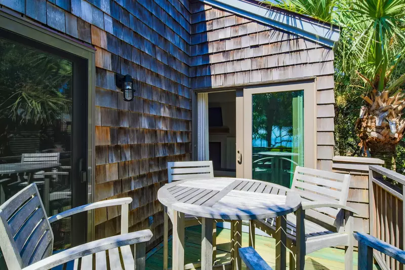 The back deck is accessible from both the living room and bedroom.