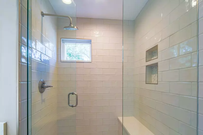 The bathroom also has a tiled, walk-in shower with bench seating.