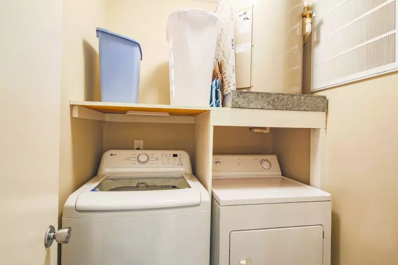 There is full-sized washing machine and dryer in the laundry room near the front door.