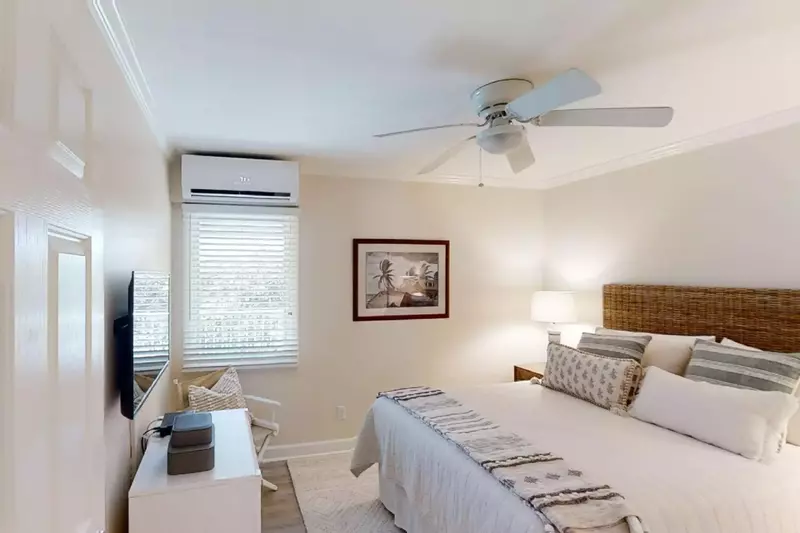Guest bedroom with ceiling fan, smart TV