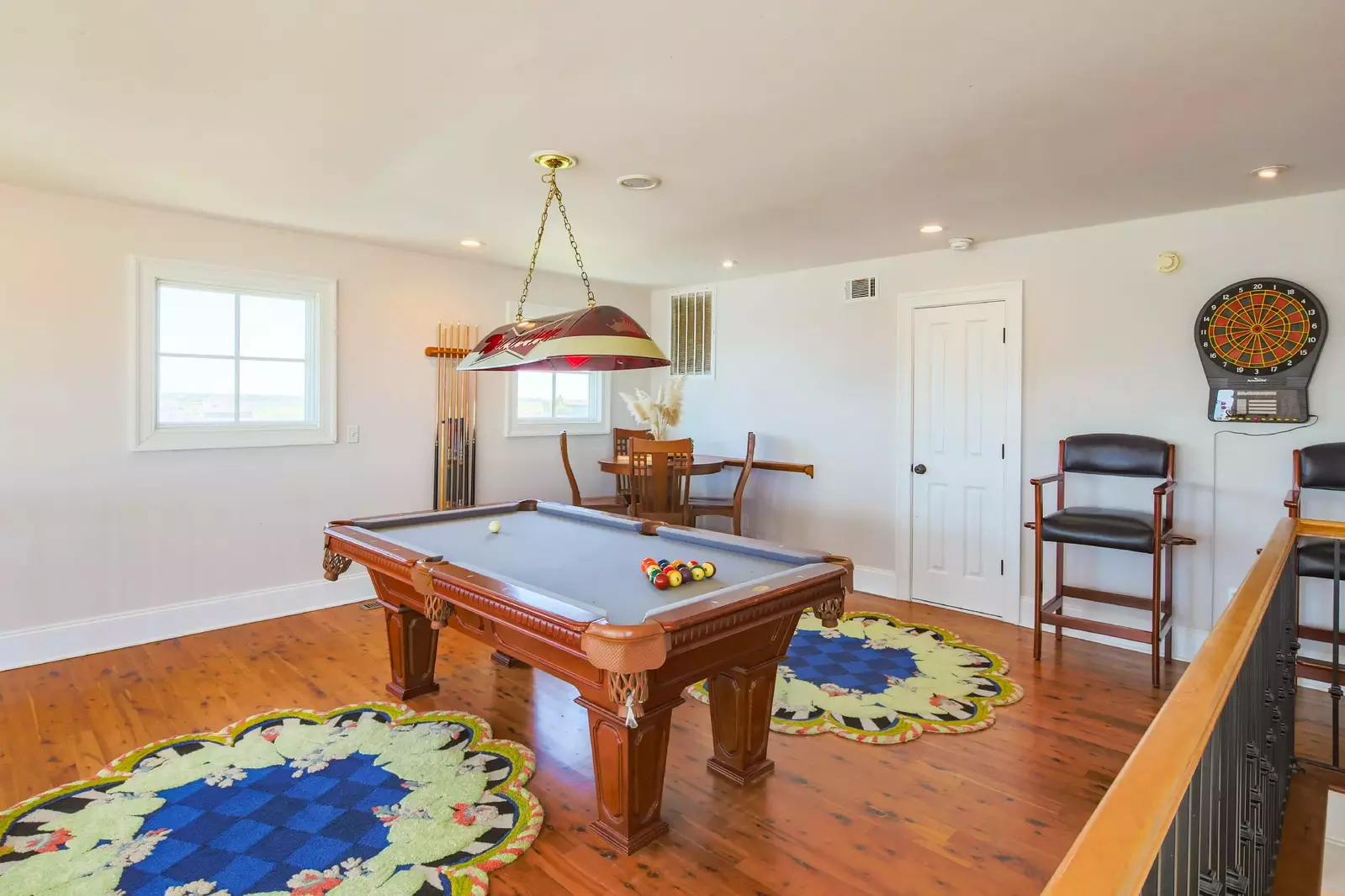 The third floor of the home features a game room with a pool table, dart board and card table.