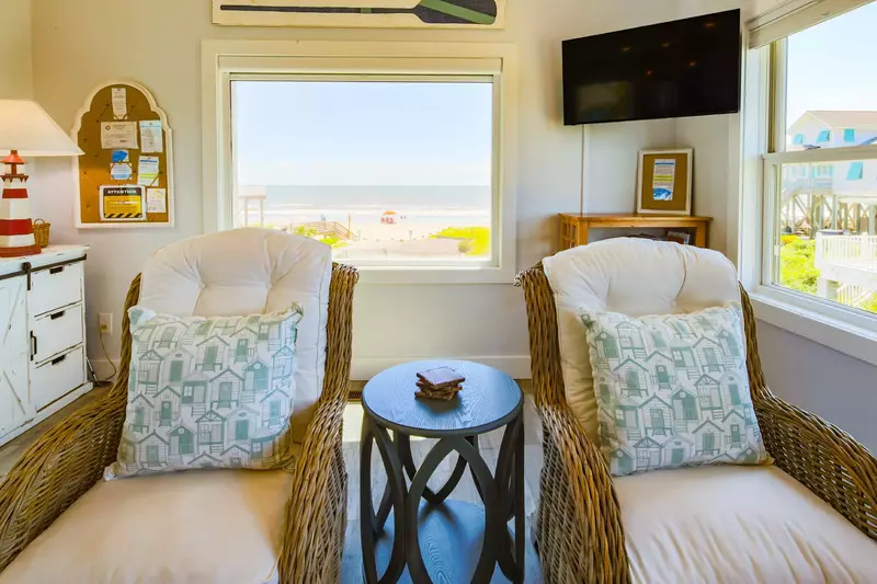 The living room also has a wall-mounted smart TV and mesmerizing ocean views.