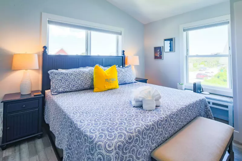 The master suite features a king bed and night stands with reading lamps.