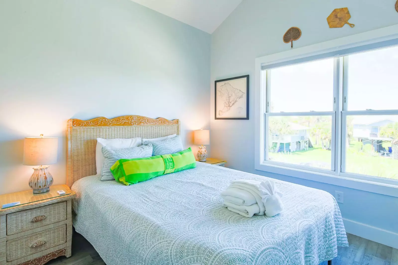 This guest bedroom features a queen bed and night stands with reading lamps.